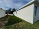 Side view highlighting the home's crisp white exterior, window placement, and well kept lawn at 37533 Teri Ct, Dade City, FL 33525