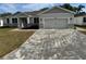 Charming single-story home with a two-car garage, stone accents, and well-maintained landscaping at 37533 Teri Ct, Dade City, FL 33525