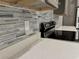 Close-up of modern kitchen featuring quartz countertops, designer backsplash, and stainless steel appliances at 37533 Teri Ct, Dade City, FL 33525