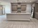 New kitchen with an island, stainless appliances, and tile backsplash at 37533 Teri Ct, Dade City, FL 33525