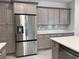 Modern kitchen features stainless steel refrigerator and lots of gray cabinets and storage at 37533 Teri Ct, Dade City, FL 33525