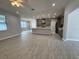 Open concept living area with kitchen and wood-look tile flooring at 37533 Teri Ct, Dade City, FL 33525