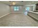Open-concept living room and kitchen area featuring modern lighting and ample space at 37533 Teri Ct, Dade City, FL 33525