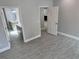 Spacious main bedroom leading into a bathroom and featuring sleek, modern tile floors at 37533 Teri Ct, Dade City, FL 33525