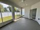 Enclosed patio features a ceiling fan, large windows, and a view of the backyard and fence at 37533 Teri Ct, Dade City, FL 33525