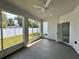 Enclosed patio features a ceiling fan, large windows, and a view of the backyard and fence at 37533 Teri Ct, Dade City, FL 33525
