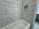 White marble subway tiled tub in the bathroom at 37533 Teri Ct, Dade City, FL 33525