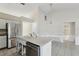 Open concept kitchen with white cabinets, a stainless steel fridge, and tile flooring at 4025 Meadow Run Ln, Wesley Chapel, FL 33543
