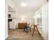 Bright dining area featuring wood-look tile flooring, a modern table, and updated kitchen at 408 S Arrawana Ave # A4, Tampa, FL 33609
