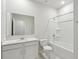 Bright bathroom features a shower-tub combo and a white single sink vanity at 4086 Polynesia Rd, North Port, FL 34288