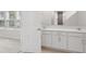 Bathroom with double sink vanity and neutral ceramic tile flooring at 4086 Polynesia Rd, North Port, FL 34288