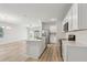 Open-concept kitchen featuring a central island, stainless steel appliances, and hardwood floors at 4086 Polynesia Rd, North Port, FL 34288
