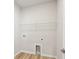 Utility room with hardwood floors and white walls at 4086 Polynesia Rd, North Port, FL 34288