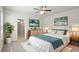 A staged bedroom with a bed, dresser, nightstands and decor at 4086 Polynesia Rd, North Port, FL 34288