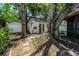 Charming backyard with a shed, surrounded by mature trees and a stone pathway at 420 S Matanzas Ave, Tampa, FL 33609