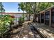 Beautiful backyard featuring a stone pathway, lush greenery and a screened patio in a serene setting at 420 S Matanzas Ave, Tampa, FL 33609