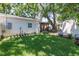 Well-maintained backyard with lush green grass, mature trees, and a screened-in porch for outdoor relaxation at 420 S Matanzas Ave, Tampa, FL 33609