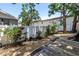A backyard deck with white fence, landscaping, and a stone path, perfect for outdoor entertaining at 420 S Matanzas Ave, Tampa, FL 33609