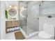 Modern bathroom featuring a glass-enclosed shower, a round mirror with lights, and a stylish vanity at 420 S Matanzas Ave, Tampa, FL 33609