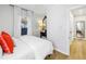 Light and airy bedroom with white bedding, decorative mirror and natural light filtering through the window at 420 S Matanzas Ave, Tampa, FL 33609