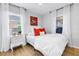 Bright bedroom with warm wood floors, soft lighting, and charming decor for a relaxing atmosphere at 420 S Matanzas Ave, Tampa, FL 33609