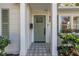 Charming front entrance featuring a green door, decorative tiling, and well-maintained landscaping at 420 S Matanzas Ave, Tampa, FL 33609