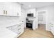 Modern kitchen with white cabinets, stainless steel appliances, marble countertops, and a view into the dining area at 420 S Matanzas Ave, Tampa, FL 33609