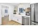 Stylish kitchen featuring white cabinets, a farmhouse sink, stainless steel appliances, and plenty of natural light at 420 S Matanzas Ave, Tampa, FL 33609