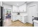 Bright kitchen with white cabinetry, marble countertops, and an open layout connecting to the adjacent living room at 420 S Matanzas Ave, Tampa, FL 33609