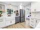 Modern kitchen featuring white cabinets, stainless steel appliances, and a farmhouse sink with a view to the Gathering room at 420 S Matanzas Ave, Tampa, FL 33609
