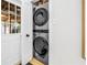Modern laundry room with a stacked washer and dryer set, featuring a stylish and efficient design at 420 S Matanzas Ave, Tampa, FL 33609