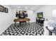 Well-lit home office with stylish desk, modern décor, geometric flooring, and entertainment center at 420 S Matanzas Ave, Tampa, FL 33609