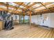 Large covered wooden patio with ambient lighting, screened walls, and an outdoor grill at 420 S Matanzas Ave, Tampa, FL 33609