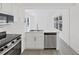 Bright kitchen features stainless appliances, white cabinetry, and eat-in counter at 4426 4Th N Ave, St Petersburg, FL 33713