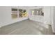 Bright living room boasts natural light, wood-look floors, and white paneled walls at 4426 4Th N Ave, St Petersburg, FL 33713