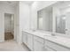 Elegant primary bathroom featuring double vanities, quartz countertops, and a glass-enclosed shower at 4810 Prime Ter, North Port, FL 34286
