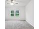 Neutral bedroom featuring carpet, a ceiling fan, two windows and light walls at 4810 Prime Ter, North Port, FL 34286