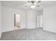 Spacious bedroom with carpet, white walls, and doorways into other rooms and the ensuite bath at 4810 Prime Ter, North Port, FL 34286