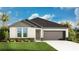 Charming single-story home featuring a well-manicured lawn, two-car garage, and classic architectural details at 4810 Prime Ter, North Port, FL 34286
