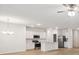 Open-concept living space with modern kitchen, stainless steel appliances, and wood-style floors at 4810 Prime Ter, North Port, FL 34286