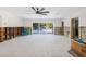 Spacious living room with sliding glass doors offering views of the backyard pool area at 4901 Venetian Ne Blvd, St Petersburg, FL 33703