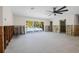 Large living room with a view of the backyard pool, ceiling fan, and sliding glass doors for plenty of natural light at 4901 Venetian Ne Blvd, St Petersburg, FL 33703