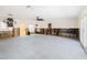 View of a large living room with modern light fixtures, natural light, and ample renovation space at 4901 Venetian Ne Blvd, St Petersburg, FL 33703