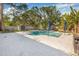Beautiful backyard pool area with a small shed, privacy fence, and meticulously designed patio, perfect for relaxation at 4901 Venetian Ne Blvd, St Petersburg, FL 33703