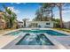 Backyard oasis featuring a luxurious pool, spa, and spacious patio area perfect for entertaining at 4901 Venetian Ne Blvd, St Petersburg, FL 33703