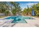Backyard with a blue tiled swimming pool and patio at 4901 Venetian Ne Blvd, St Petersburg, FL 33703