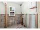 Utility room with exposed framework, water heater, window and pipes at 4901 Venetian Ne Blvd, St Petersburg, FL 33703