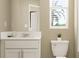 Bright bathroom with vanity, modern fixtures, window, and a toilet at 5129 Benjamin Eric St, Zephyrhills, FL 33541