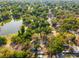 Aerial view of a neighborhood with lush trees and a nearby lake, highlighting the community's natural beauty at 5804 N 9Th St, Tampa, FL 33604