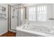 Bright bathroom featuring walk-in shower and soaking tub at 5804 N 9Th St, Tampa, FL 33604